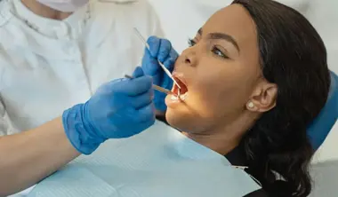 Dentist Working In Patient Mouth